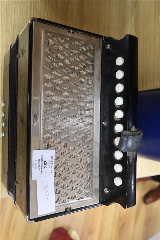 A Hohner Melodian Accordian and booklet